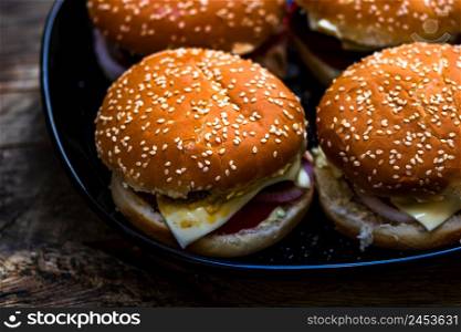 Closeup of fresh homemade tasty burgers on wooden table