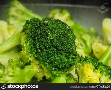 Closeup of fresh steamed green broccoli in fry pan