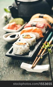 Closeup of fresh sushi on rustic wooden table, close up. Closeup of fresh sushi on rustic wooden table