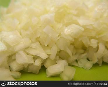 Closeup of freshly chopped onion, on chop board