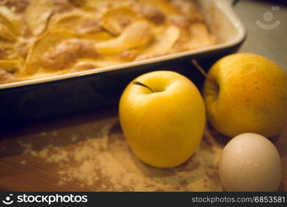 Closeup of freshly made apple and golden apples on kitchen table