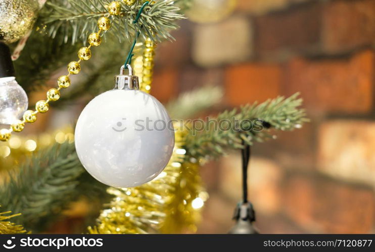 Closeup of Glitter Ball hanging from a decorated Christmas tree. Retro filter effect, AF point selection.