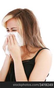 Closeup of gorgeous caucasian woman with cold sneezing into tissue over white background