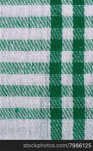 Closeup of green checked fabric background.