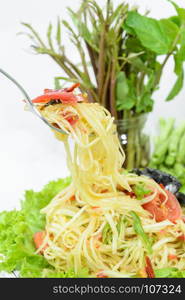 Closeup of Green Papaya salad or Somtum with pickled crab on white background. Famous Thai spicy street food in Thailand