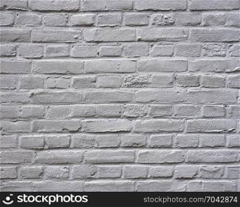 closeup of grey painted horizontal part of brick wall