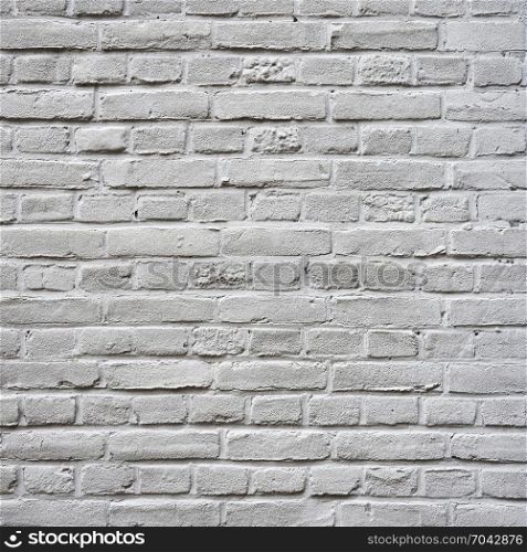 closeup of grey painted square part of brick wall