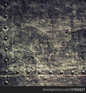 Closeup of grunge black metal plate with rivets and screws as background or texture. Square format.