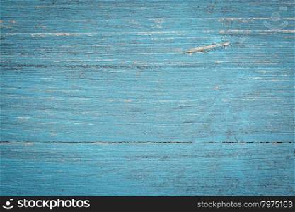 closeup of grunge blue painted, rough wood background