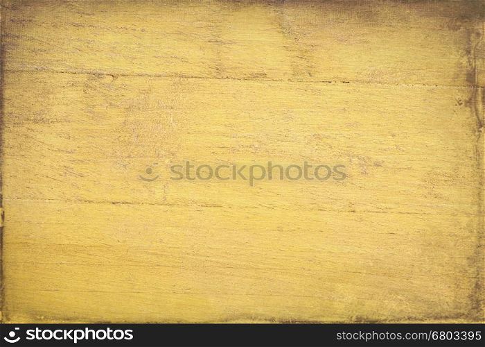 closeup of grunge yellow painted, rough wood background