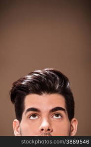 Closeup of half head of man with great hairstyle over brown background