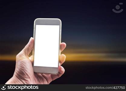 Closeup of hand using mobile with blank screen at sunset background. Network connection technology background concept.