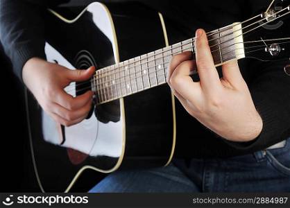 closeup of hands of a musician playing guitar