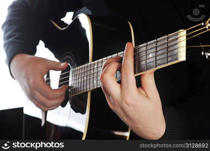 closeup of hands of a musician playing guitar