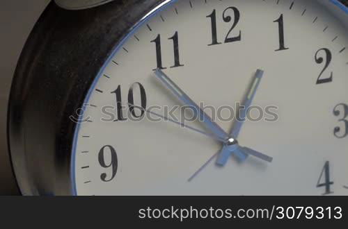 Closeup of hands on clock face. Time concept