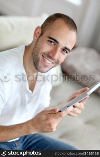 Closeup of handsome man websurfing on touchpad