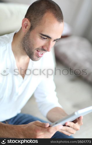 Closeup of handsome man websurfing on touchpad