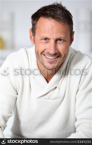 Closeup of hansdsome man with white sweater