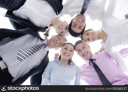 Closeup of happy business people with their heads together representing concept of ftiendship and teamwork isolated on white background