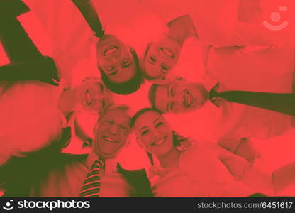 Closeup of happy business people with their heads together representing concept of ftiendship and teamwork isolated on white background