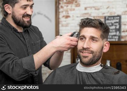Closeup of happy man getting an haircut, in hair salon. High quality photo.. Closeup of happy man getting an haircut, in hair salon. High quality photo