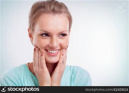 Closeup of happy young woman smiling and side looking