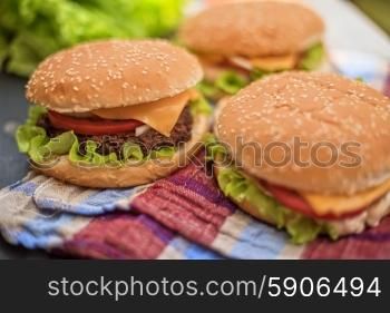 Closeup of home made burgers on wooden table. home made burgers