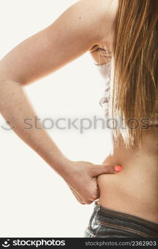 Closeup of human holding pinching fat body hip. Overweight cellulitis.. Human holding pinching fat body hip.