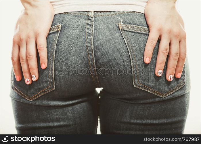Closeup of human with hands palms on buttocks ass in jeans trousers.. Human with hands on buttocks ass in jeans trousers