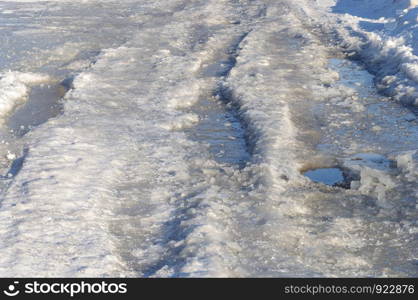Closeup of ice-covered road background, winter day