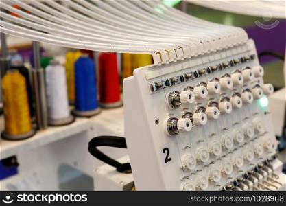 Closeup of industrial twin head embroidery machine. Selective focus.