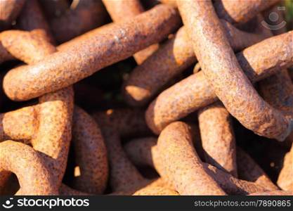 Closeup of large rusty old used chain links as background texture