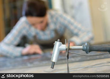 Closeup of lead machine, artist in background