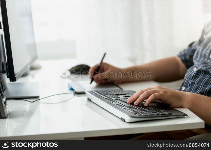 Closeup of male designer using graphic tablet