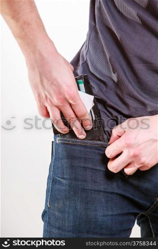 Closeup of male hands. Careless man putting the wallet and bill of sell in his pocket. Risk of theft. Isolated on white. Studio shot.