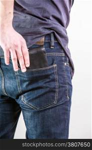 Closeup of male hands. Careless man taking the wallet out on his back pocket. Risk of theft. Isolated on white. Studio shot.