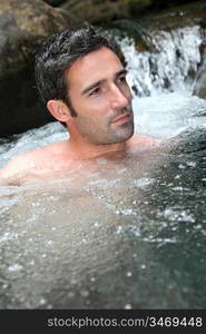 Closeup of man bathing in natural river water