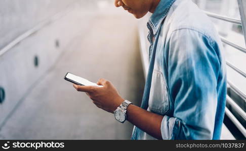 Closeup of man holding a smartphone, mock up of blank screen. using cell phone on lifestyle. Technology for communication concept.