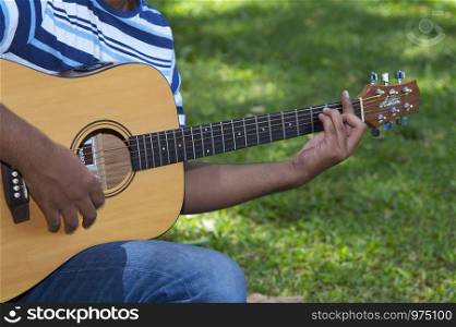 Closeup of man playing guitar