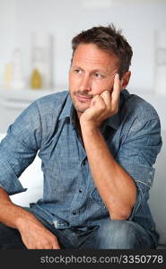 Closeup of man sitting in sofa