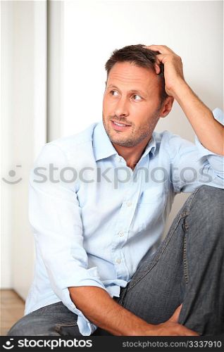 Closeup of man sitting on the floor at home