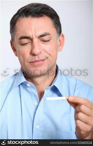 Closeup of man trying to quit smoking