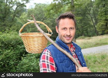 Closeup of man with basket looking for mushrooms on the ground