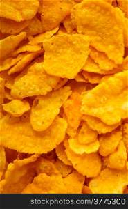Closeup of many corn flakes breakfast morning meal as food background. Diet and healthy nutrition.