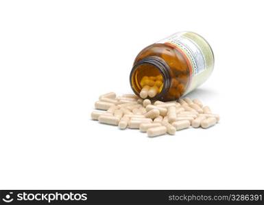 closeup of medical bottle and heap of pills fallen out from