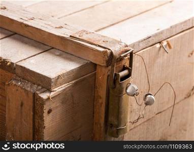 Closeup of metal latch with seal on old wooden chest
