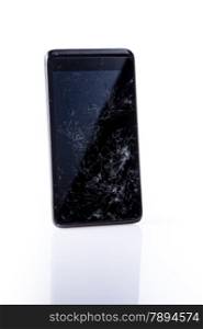 Closeup of mobile smartphone with broken screen, on white with reflection