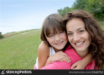 Closeup of mother and daughter in countryside