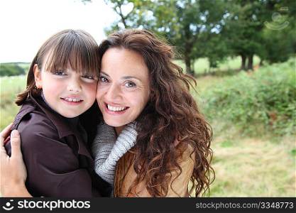 Closeup of mother and daughter in countryside