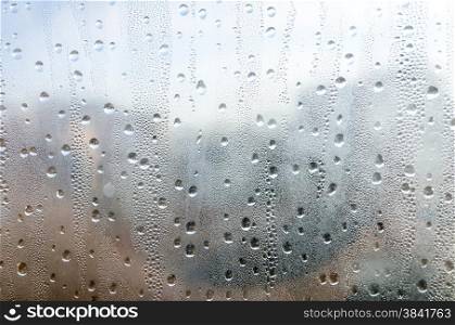 Closeup of natural water drop on glass background